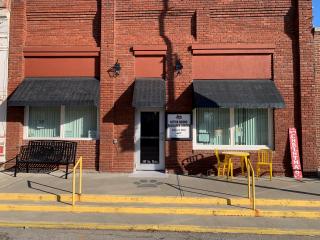 New table, bench, and entrance door.