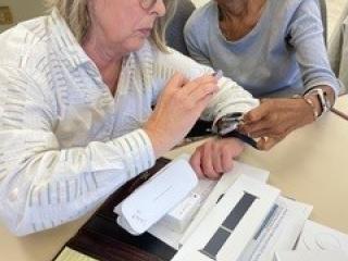 Older adult learning to use smartwatch.