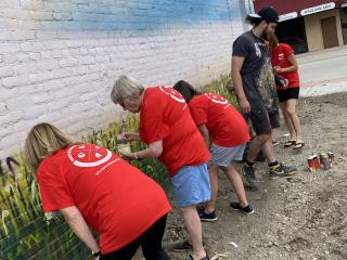 Volunteers painting mural.