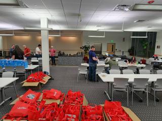 Volunteers packing bags with sensory friendly amenities like noise canceling headphones.