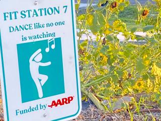 FItness station in community garden advising "Dance like no one is watching."