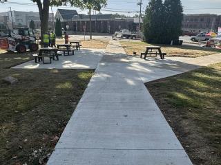 New picnic tables and sidewalk.