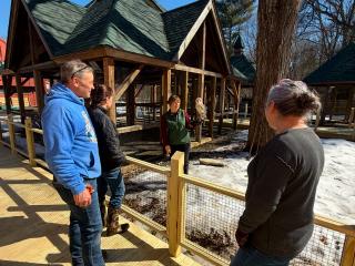 Woman holding owl next to new raised walkway.