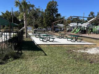 New large concrete pad with picnic tables.