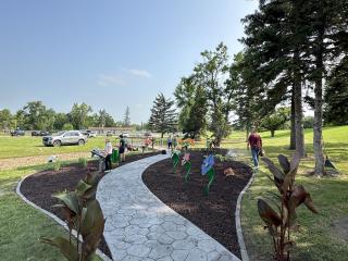 Volunteers spreading mulch around musical instruments.