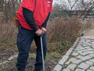 Garden volunteer using ergonomic weed puller.